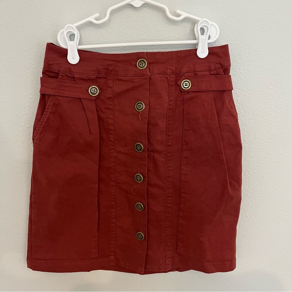 Anthropologie rust red skirt with gold accent buttons and pockets